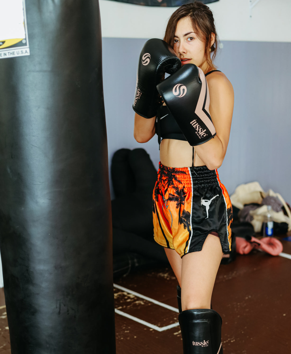 Camila wearing laceup gloves for kickboxing practice