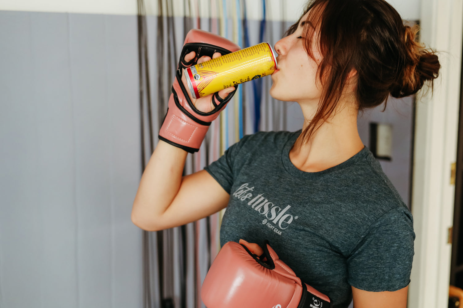 Female boxer drinking cane with wearing Tussle Hybrid Gloves