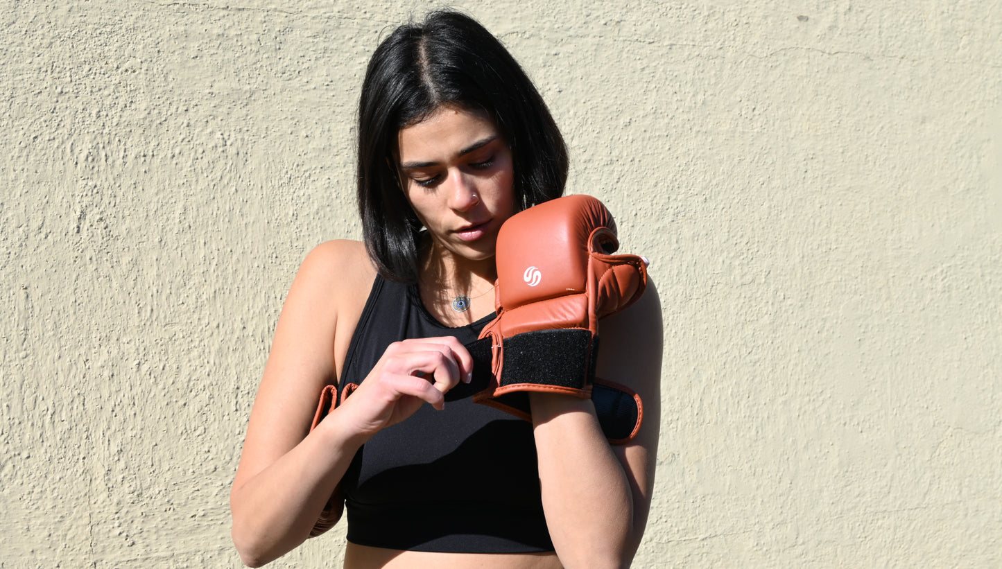 Female boxer wearing Tussle hybrid gloves