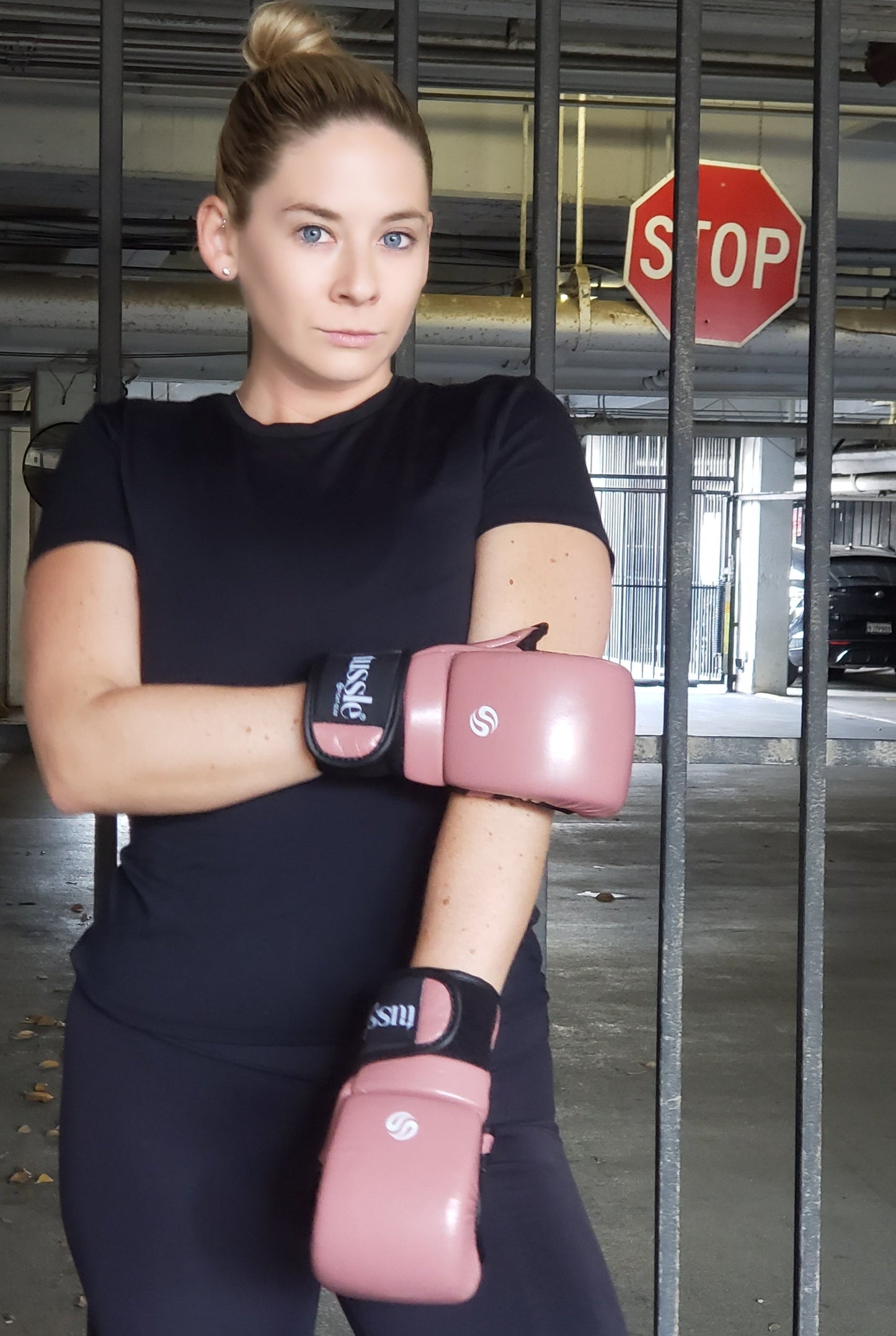 Women trainee wearing trendy rose gold Tussle hybrid gloves